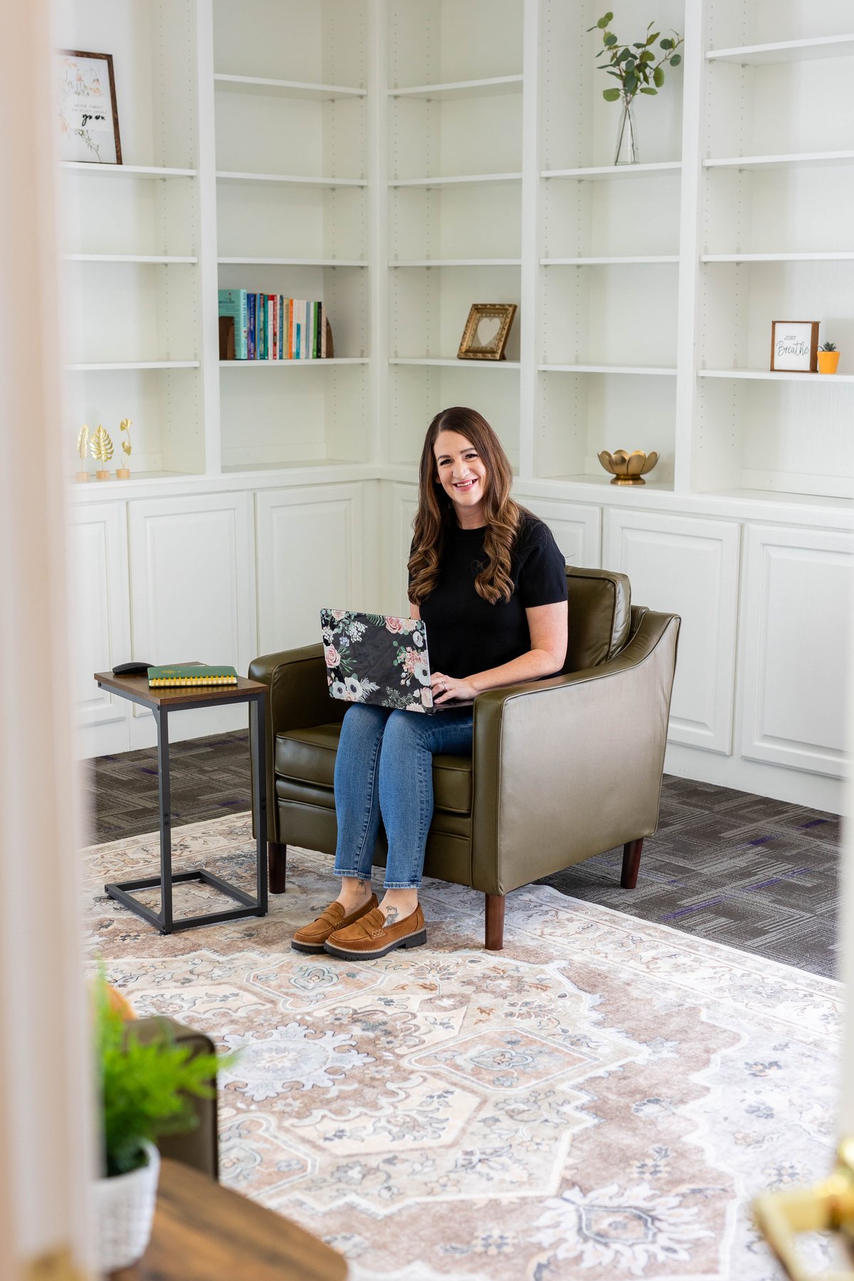 Trisha McWilliams working in her Renewed Roots Counseling office